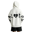 A person shown from the back wearing an oversized white hoodie with large black graphic lettering and a black heart containing the letter A on the back, paired with black shorts. The brand name AMII appears in the top left corner.