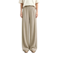 A model from the waist down wearing AMII wide-leg trousers in a light beige color, paired with a cream top and beige shoes, standing against a neutral studio background.