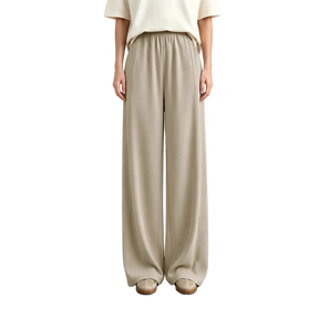 A model from the waist down wearing AMII wide-leg trousers in a light beige color, paired with a cream top and beige shoes, standing against a neutral studio background.