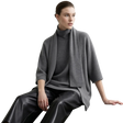 A model wearing an AMII gray knit turtleneck sweater with a draped shawl collar, paired with black leather pants, seated against a light gray background.