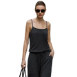 A woman wearing a dark charcoal gray sleeveless camisole top and matching drawstring pants stands outdoors against a beige stone building. The AMII brand name appears at the top left, and a product info panel on the left mentions mulberry silk and sheep wool yarn.