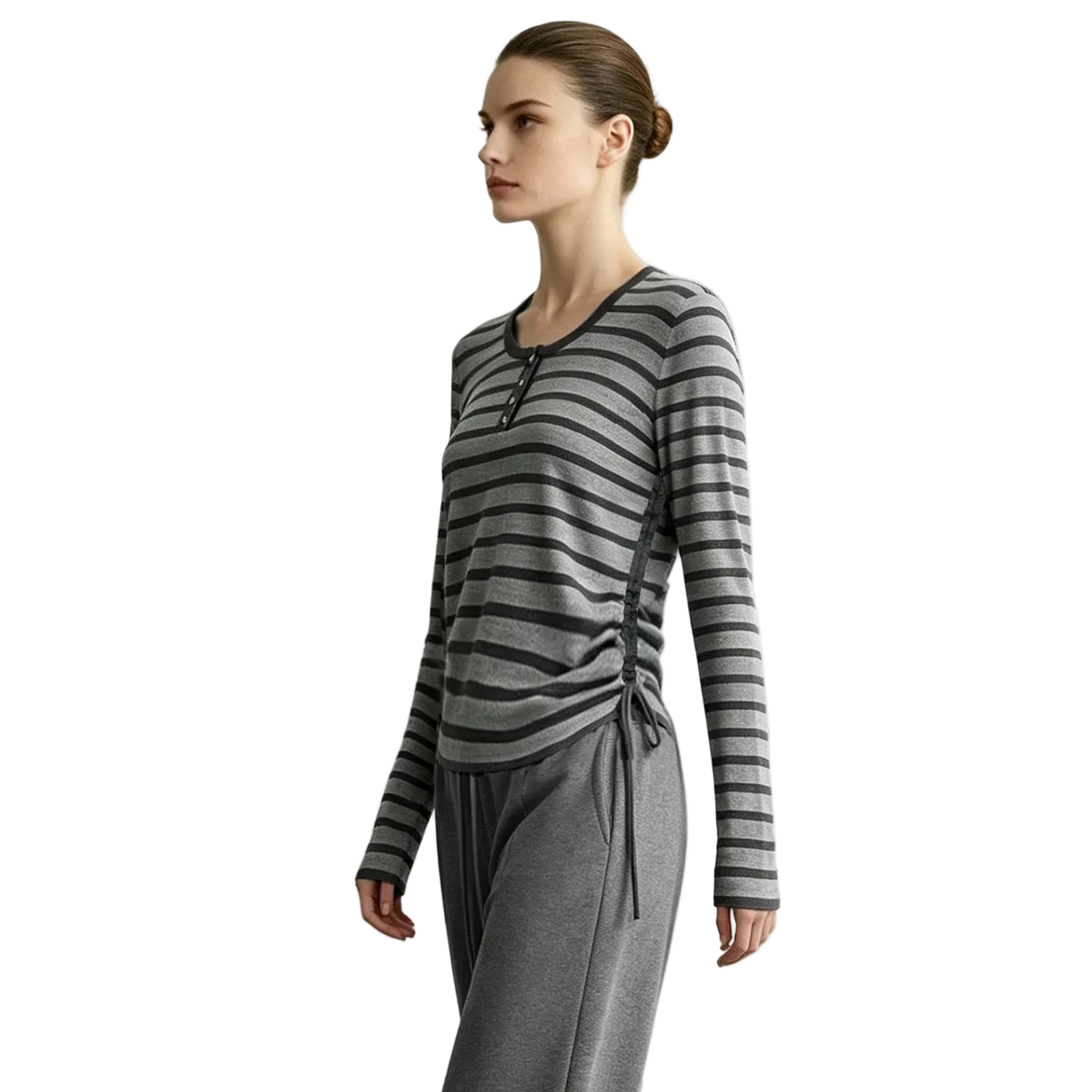A woman modeling a long-sleeve gray and black striped knit top with a side-tie detail, paired with gray drawstring pants, against a light gray studio background. The brand name AMII is printed in the top left corner.