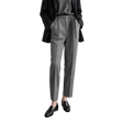 A model wearing a pair of AMII grey textured slim-fit trousers with a matching grey belt, styled with a black blazer, grey top, and black loafers against a minimalist studio background.