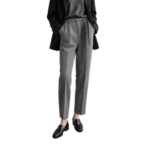 A model wearing a pair of AMII grey textured slim-fit trousers with a matching grey belt, styled with a black blazer, grey top, and black loafers against a minimalist studio background.