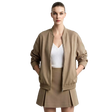 A model wearing a taupe brown bomber jacket, matching pleated mini skirt, and a white top, standing against a light gray background with the AMII logo in the top left corner.