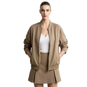 A model wearing a taupe brown bomber jacket, matching pleated mini skirt, and a white top, standing against a light gray background with the AMII logo in the top left corner.