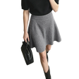 A model wearing an AMII gray knit flared skirt with a subtle glitter texture, paired with a black short-sleeve top and black boots, holding a black handbag against a minimalist studio background.